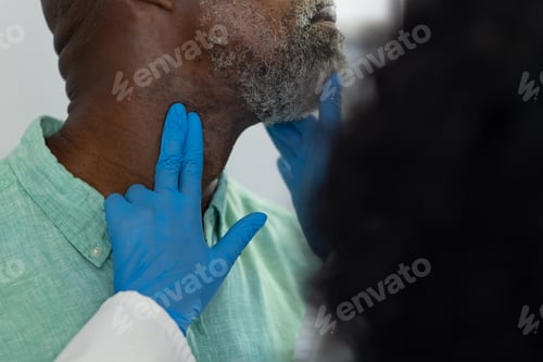 Preview: Biracial female doctor wearing medical gloves examinating african american male patient