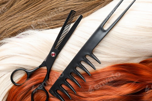 Preview: Scissors and comb on beautiful hair in different colors, top view