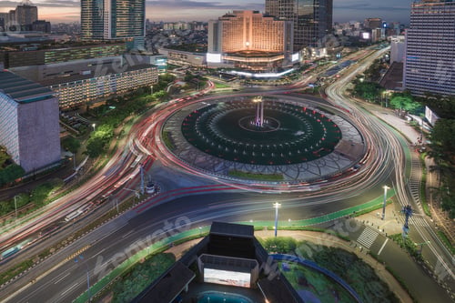 Preview: Evening cityscape with roundabout and light trails