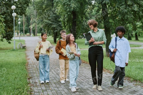 Preview: Caucasian Woman Walking Outdoors with Diverse Group of Children and Smiling