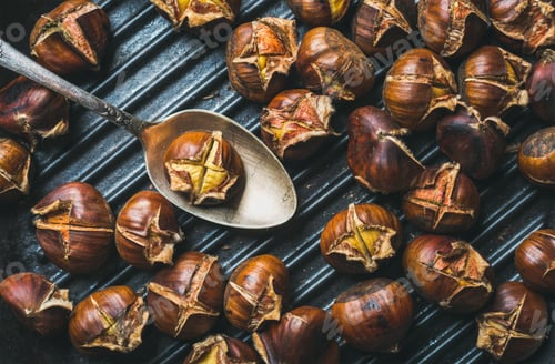 Preview: Close-up of roasted chestnuts and metal vintage spoon in pan