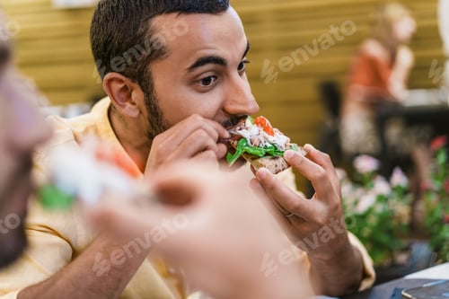 Preview: Italian man eating pizza slice in cafe - Closeup portrait of authentic local food experience