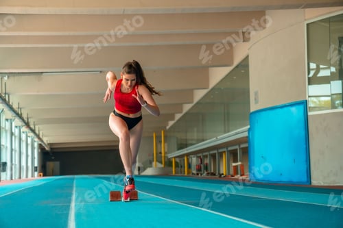 Preview: Vertical shot of a sprinter woman running at a gym