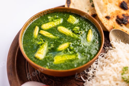Preview: palak baby corn sabzi also known as spinach makai curry served with rice or roti, Indian food