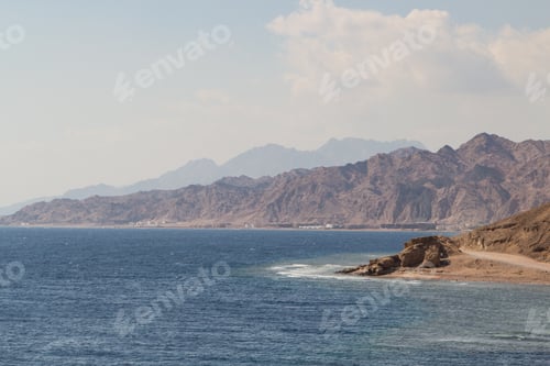 Preview: The coastline of the Red Sea with small resorts and the mountains in the background. Coral reef