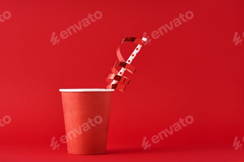 Preview: Paper coffee cup with decorations and straw on the red backgrond. Valentines day festive concept