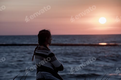 Preview: Shallow focus shot from behind of a female looking in the distance with thoughts