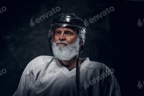 Preview: Portrait of elderly hockey player dressed in white sportswear