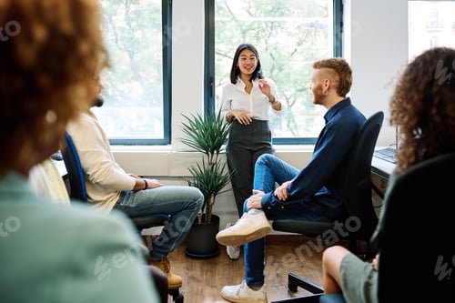 Preview: Chinese woman talking during a relaxed meeting on a coworking