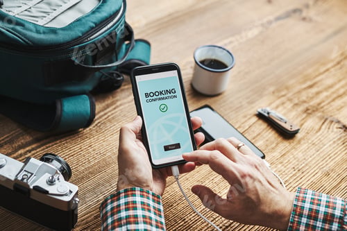 Preview: Man planning next vacation trip. Booking hotel online using smartphone. Ordering paying for service