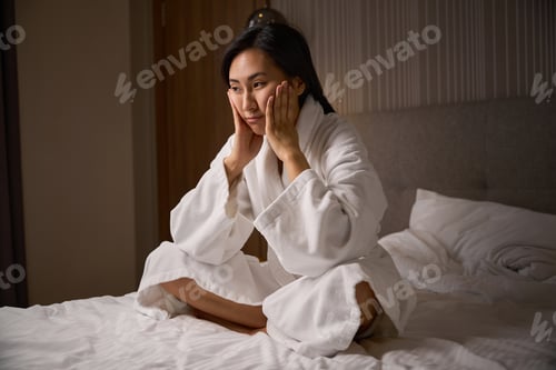 Preview: Exhausted woman leaning head on hands and contemplating about future