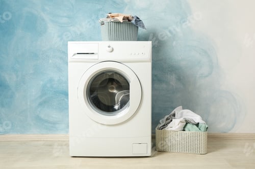Preview: Laundry room with washing machine against blue wall
