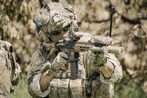 Preview: Soldier Aims Rifle in Camouflage in the Wilderness