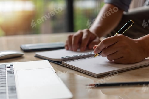 Preview: Businessperson reading and writing on book.education studying knowledge development