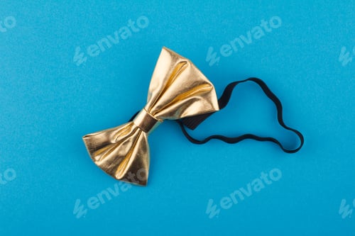 Preview: Gold Bow Tie on Bright Blue Background