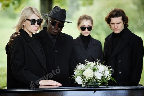Preview: Group of people standing by coffin at outdoor funeral