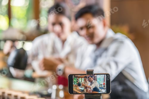 Preview: Smart mobile phone taking video to Asian two partner of small business owner vlogger