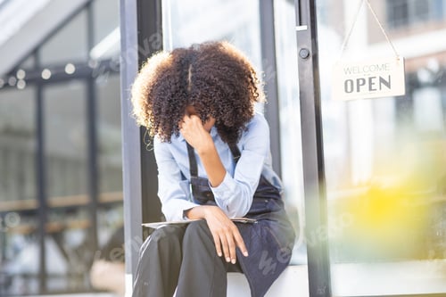 Preview: Portrait of Young african american small business owner woman wearing apron and looking away to you