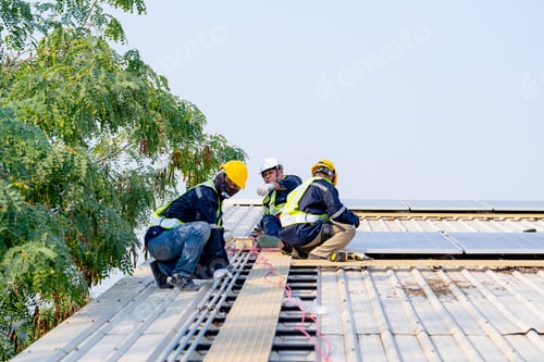 Preview: workers installing solar panels, for efficient energy on rooftop