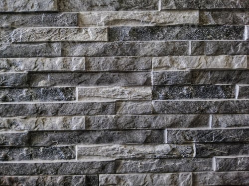 Preview: Closeup shot of a grey wall with thin bricks