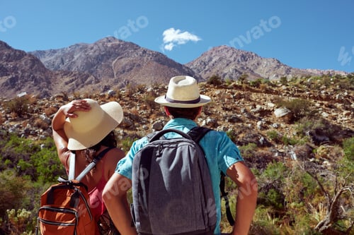 Preview: Couple hiking mountains together on a sunny day