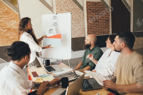 Preview: Group of young people designers having meeting in a modern office.
