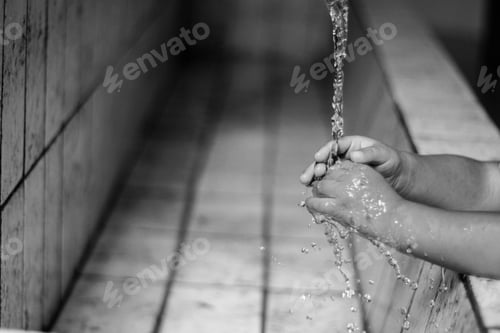 Preview: Child washing hands under flowing water