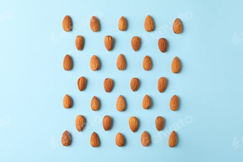 Preview: Flat lay with almond on blue background. Vitamin food
