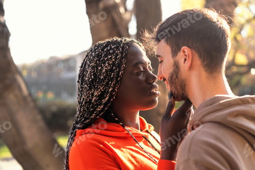 Preview: Tender Embrace - Multiracial Couple's Intimate Moment at Sunset