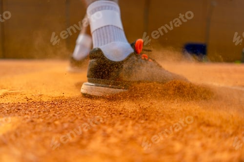 Preview: close-up of a tennis player's or instructor's foot on an outdoor court ground dust rising