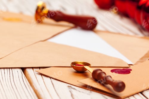 Preview: Close up of a Christmas letter with wax seal stamp on wooden table