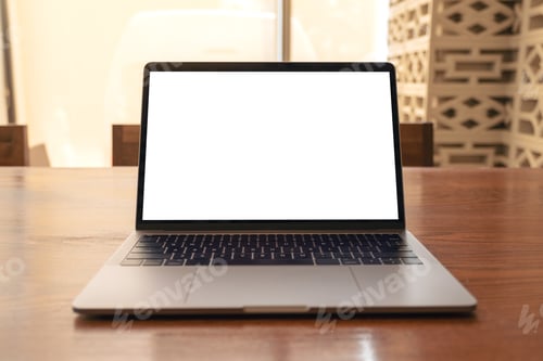 Preview: Mockup image of laptop with blank white desktop screen on wooden table