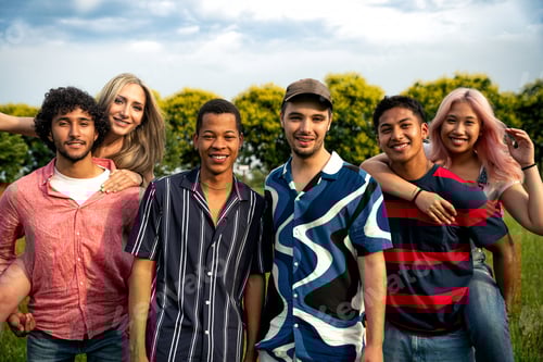 Preview: Group of multiethnic teenagers spending time outdoor on a picnic at the park