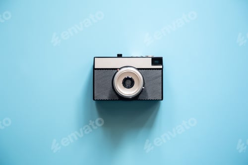Preview: Vintage retro camera on a blue background, flat lay.