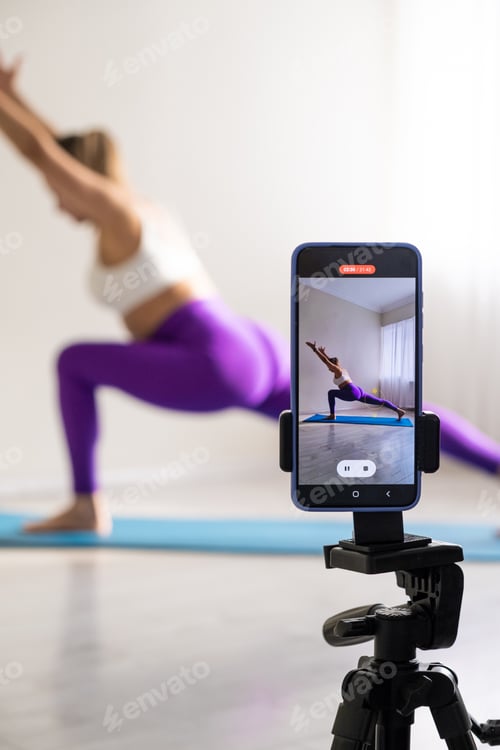Preview: woman practicing yoga poses stretching in front of phone camera sport blogger teacher yoga online