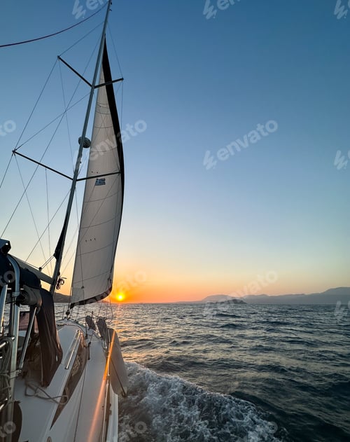 Preview: Sailing boat sailing towards the sun in Greece, Agean Sea