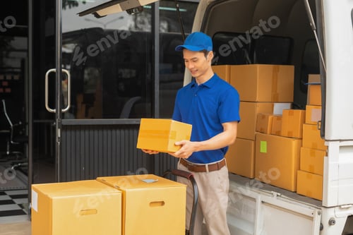 Preview: Asian delivery man work in truck for checking the product in the truck.