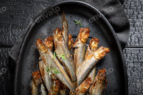 Preview: Healthy and fresh smoked sprats as appetizer by the sea.