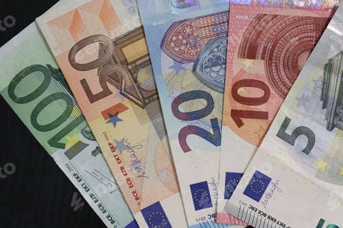 Preview: Closeup shot of euro banknotes on a black background