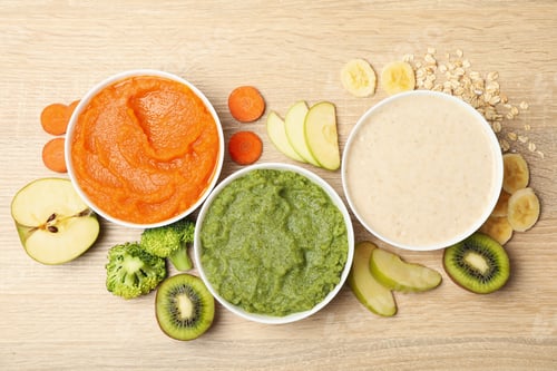 Preview: Bowls with vegetable puree on wooden background. Baby food