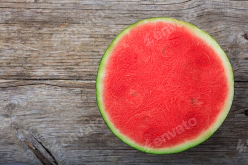 Preview: Seedless watermelon on a wooden table - top view