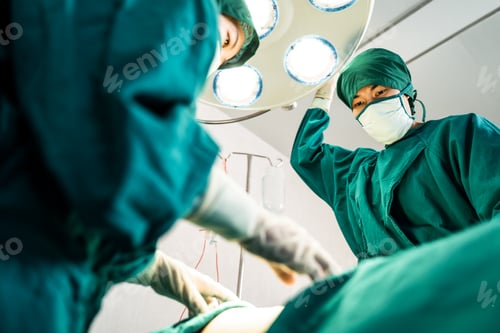 Preview: Medical Team Performing Operation Under Surgical Lights