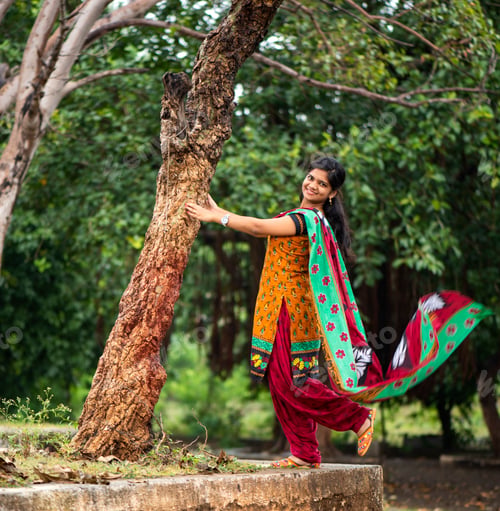 Preview: Young girl near tree trunk and she enjoying fresh air outdoors