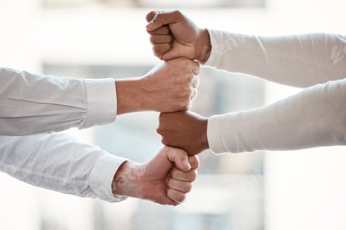 Preview: Cropped shot of two unrecognizable businessmen stacking their fisted hands in the office