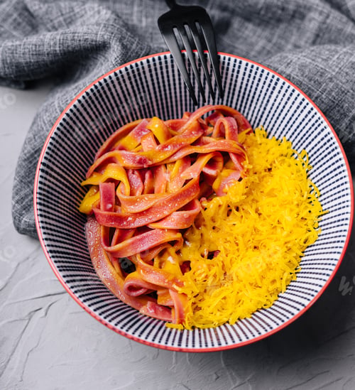 Preview: Colorful Pasta Dish with Fork on Grey Table