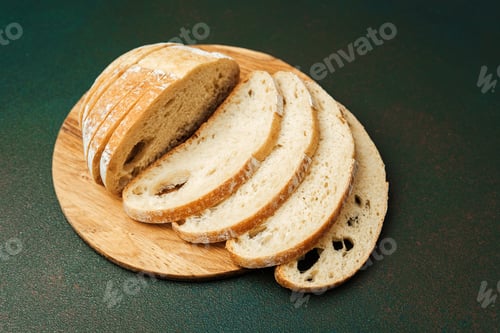 Preview: Freshly sliced artisan bread on a wooden cutting board in natural light