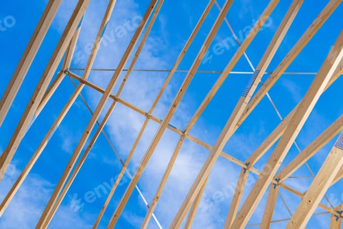 Preview: Construction Framework Showing Wooden Beams Against a Clear Blue Sky During the Day