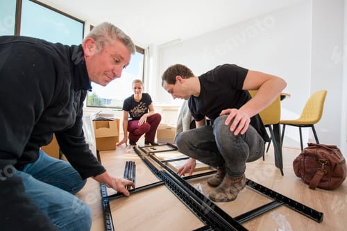 Preview: A family assembles furniture together in a bright room.