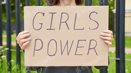 Preview: Woman Holding Girls Power Sign In Outdoor Setting