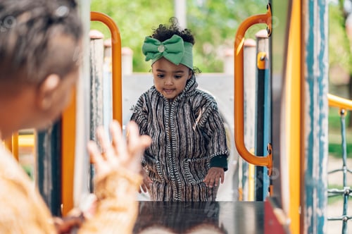 Preview: African american baby girl playing on an outdoor playground